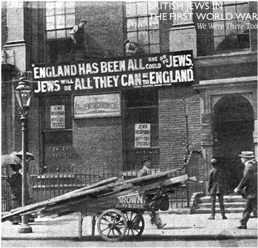 Old black & white photo of London building of the Jewish Chronicle circa 1917-1920 with large sign that reads: "England has been all she could be to Jews, Jews will be all they can be to England."